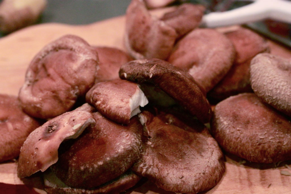 Shiitake mushrooms on a cutting board.