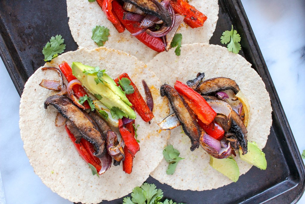 Three mushroom fajitas served on a sheetpan.